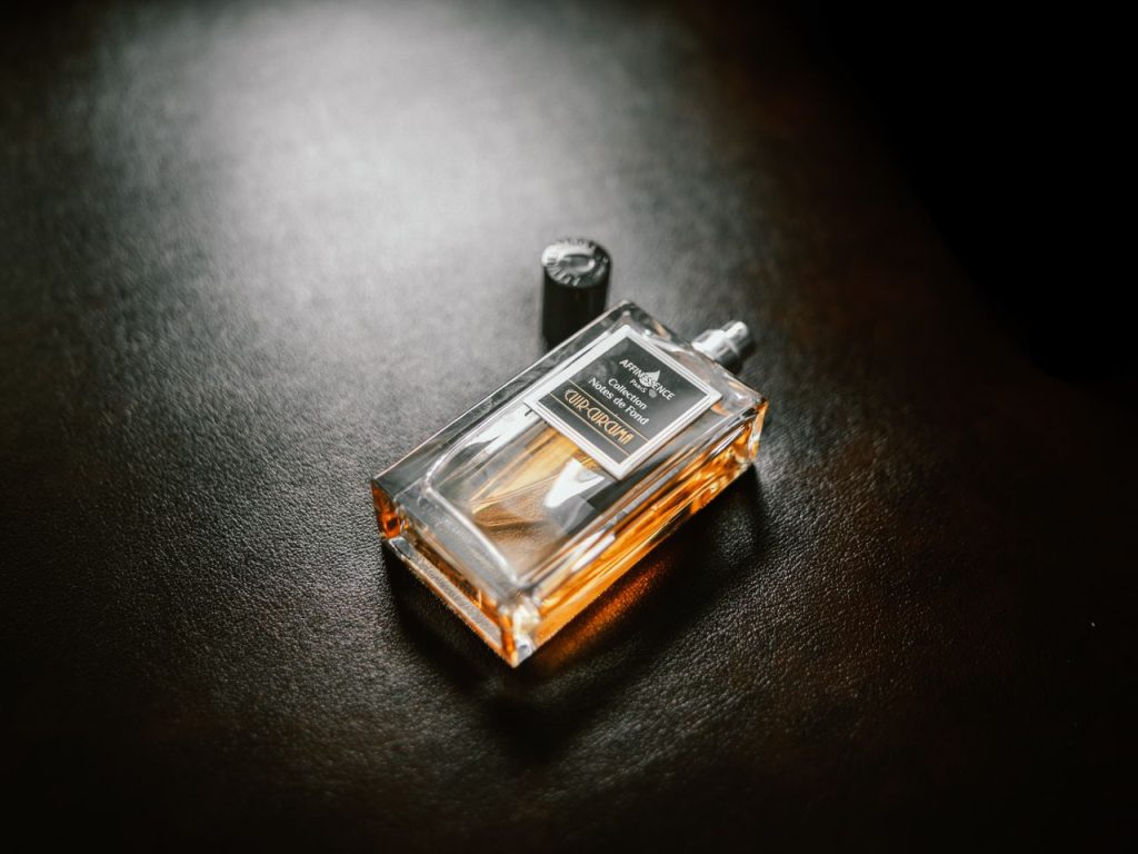 Luxurious perfume bottle with copy space on a textured dark background.