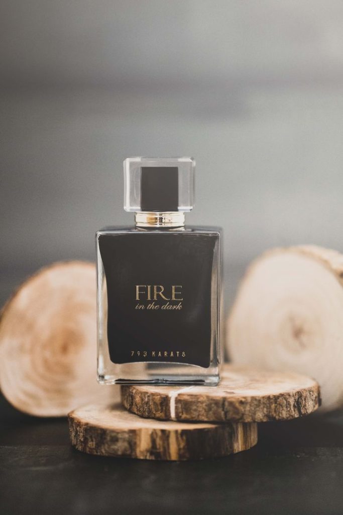 Luxurious perfume bottle displayed on rustic wood, exuding elegance.